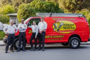 Mister Sparky electricians standing in front of branded red service van in Southern Minnesota Early Heater Maintenance